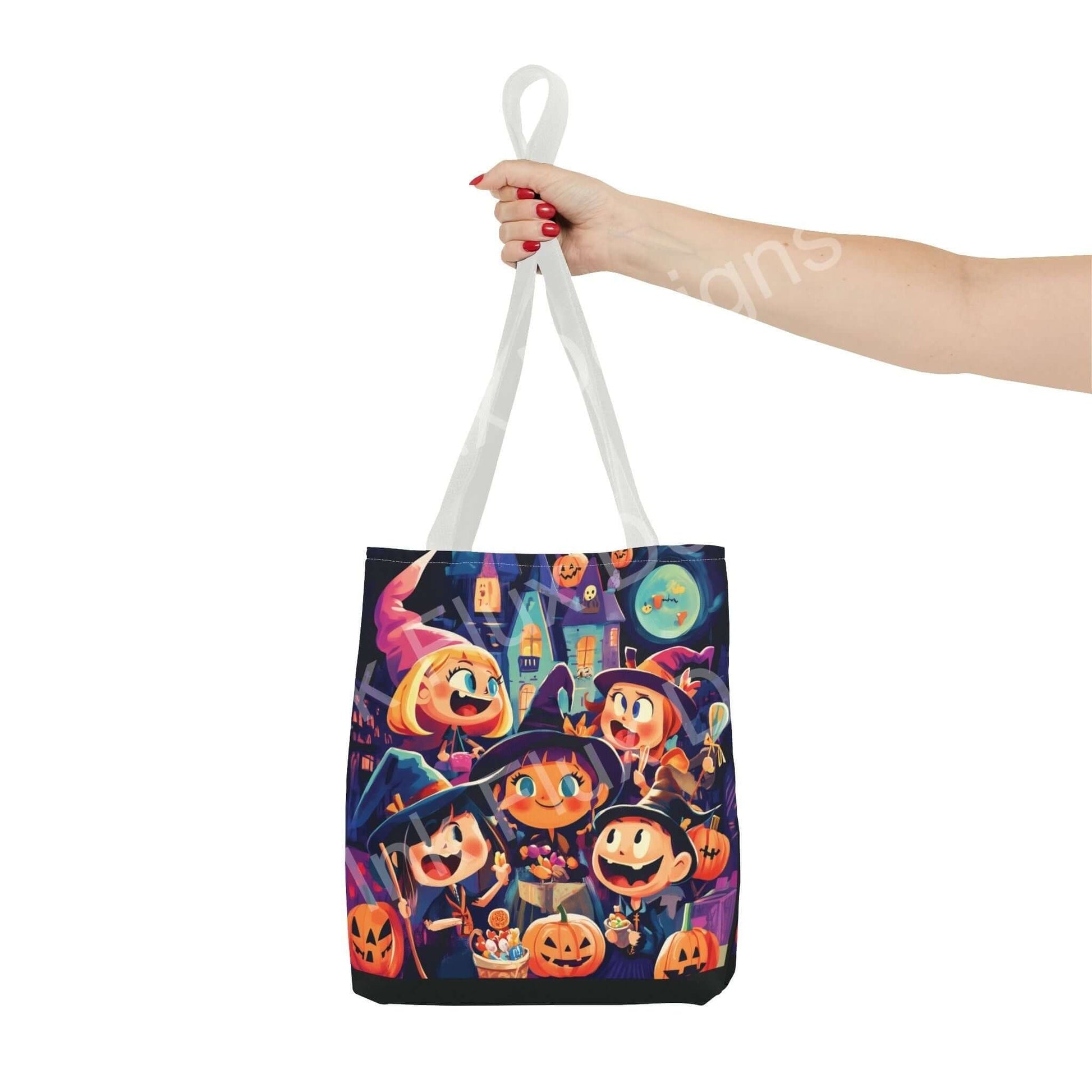 Hand holding Little Witches Tote Bag with vibrant all-over print design featuring cartoon witches, pumpkins, and haunted house, made from durable polyester.