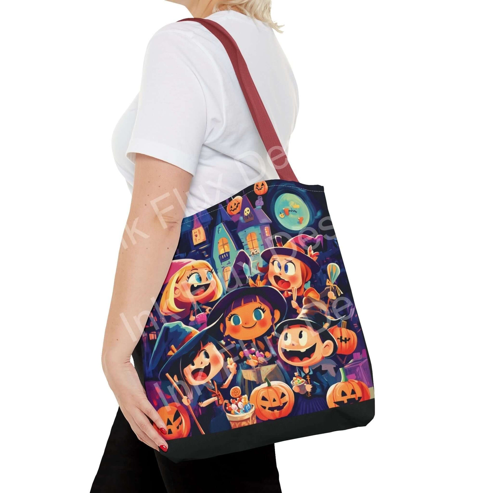 Woman carrying a Little Witches Tote Bag featuring vibrant all-over Halloween-themed print and red handle
