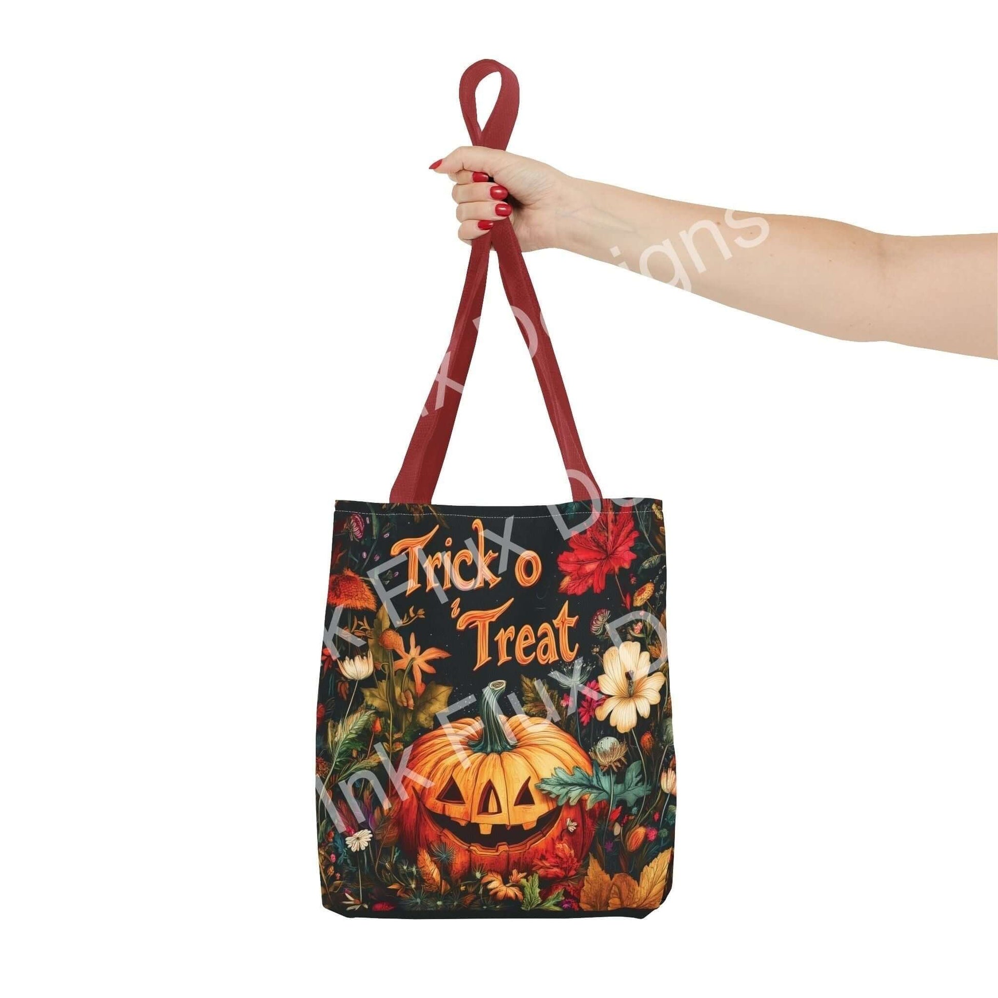 Person holding a Halloween-themed tote bag featuring a vibrant Jack o' Lantern and floral design, with red handles.