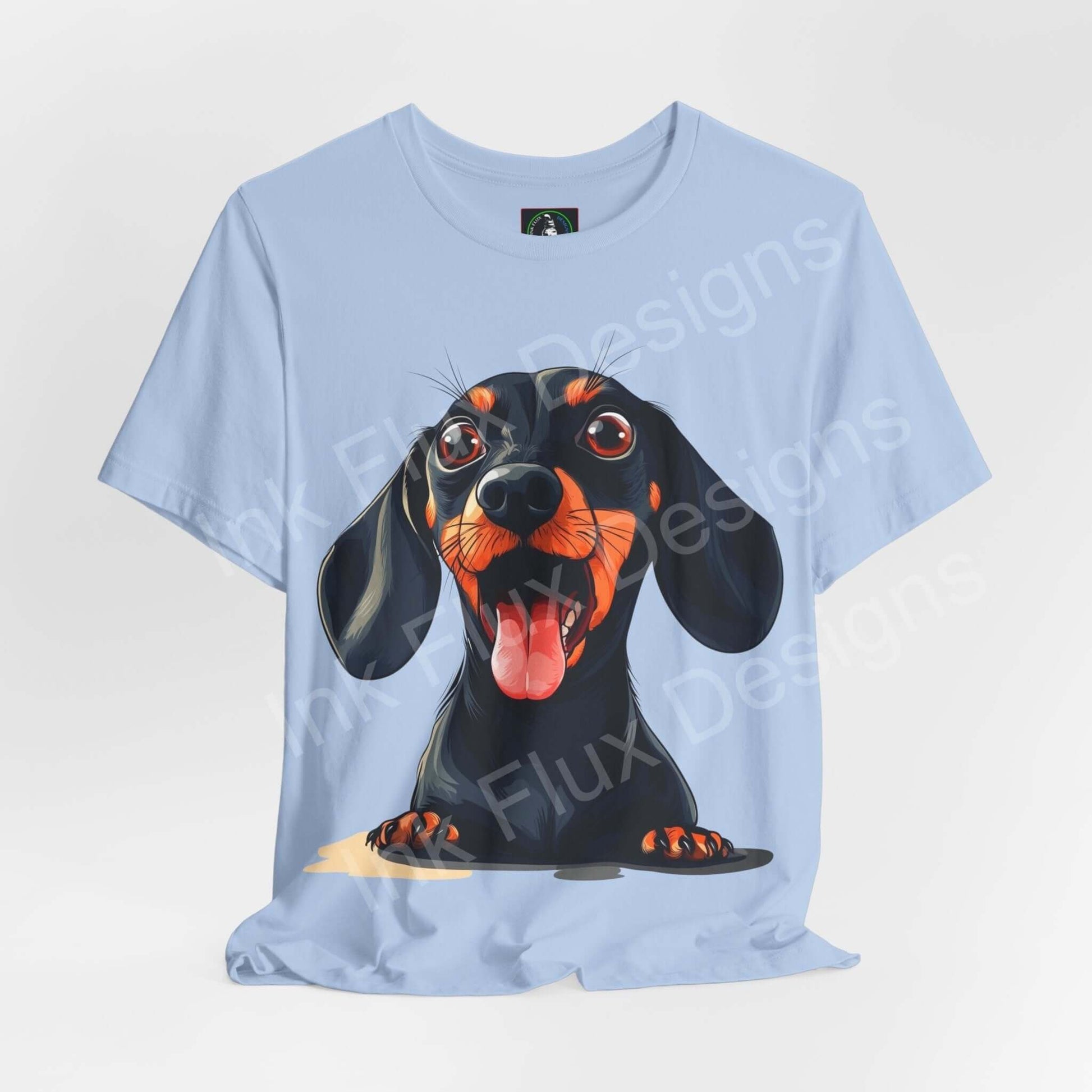 Unisex light blue T-shirt featuring a vibrant graphic of a Dachshund with a playful expression, designed by Bella+Canvas, perfect for dog lovers.