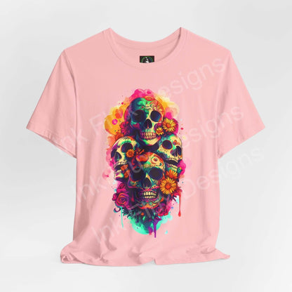 Pink Day of the Dead themed T-shirt featuring vibrant graphic skulls and flowers, suitable for DÃ­a de Muertos celebrations.
