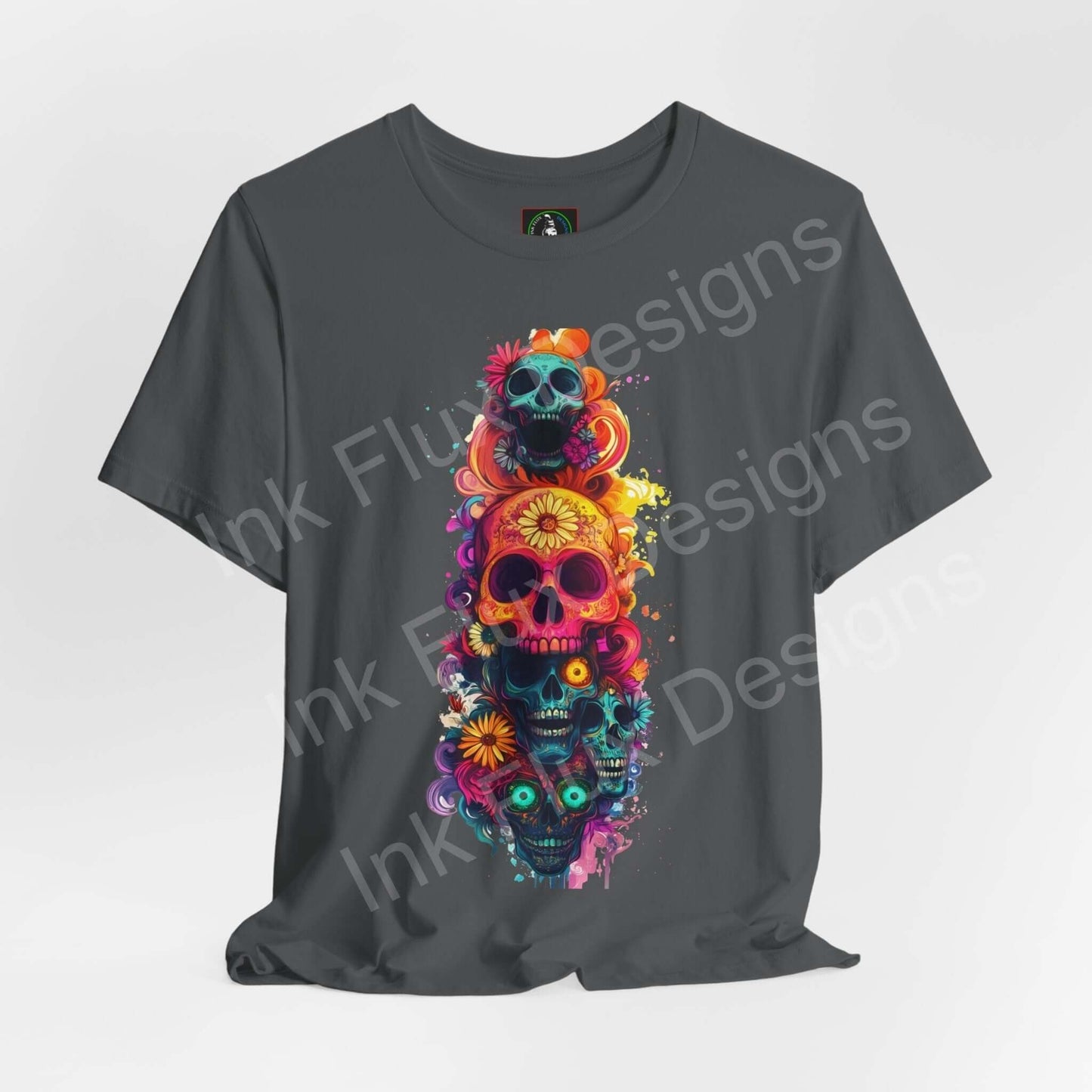 Day of the Dead themed graphic tee featuring a vibrant, colorful stack of decorated skulls on a dark grey unisex jersey T-shirt.