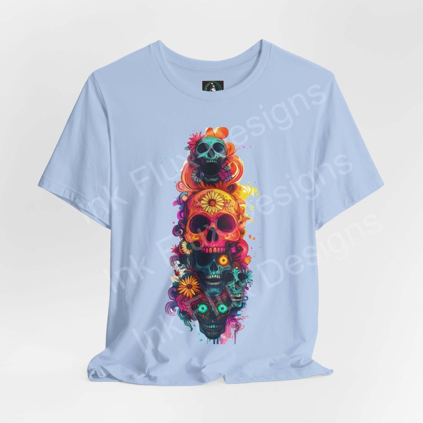 Light blue unisex T-shirt featuring colorful Day of the Dead skulls design, ideal for DÃ­a de Muertos themed graphic tees.