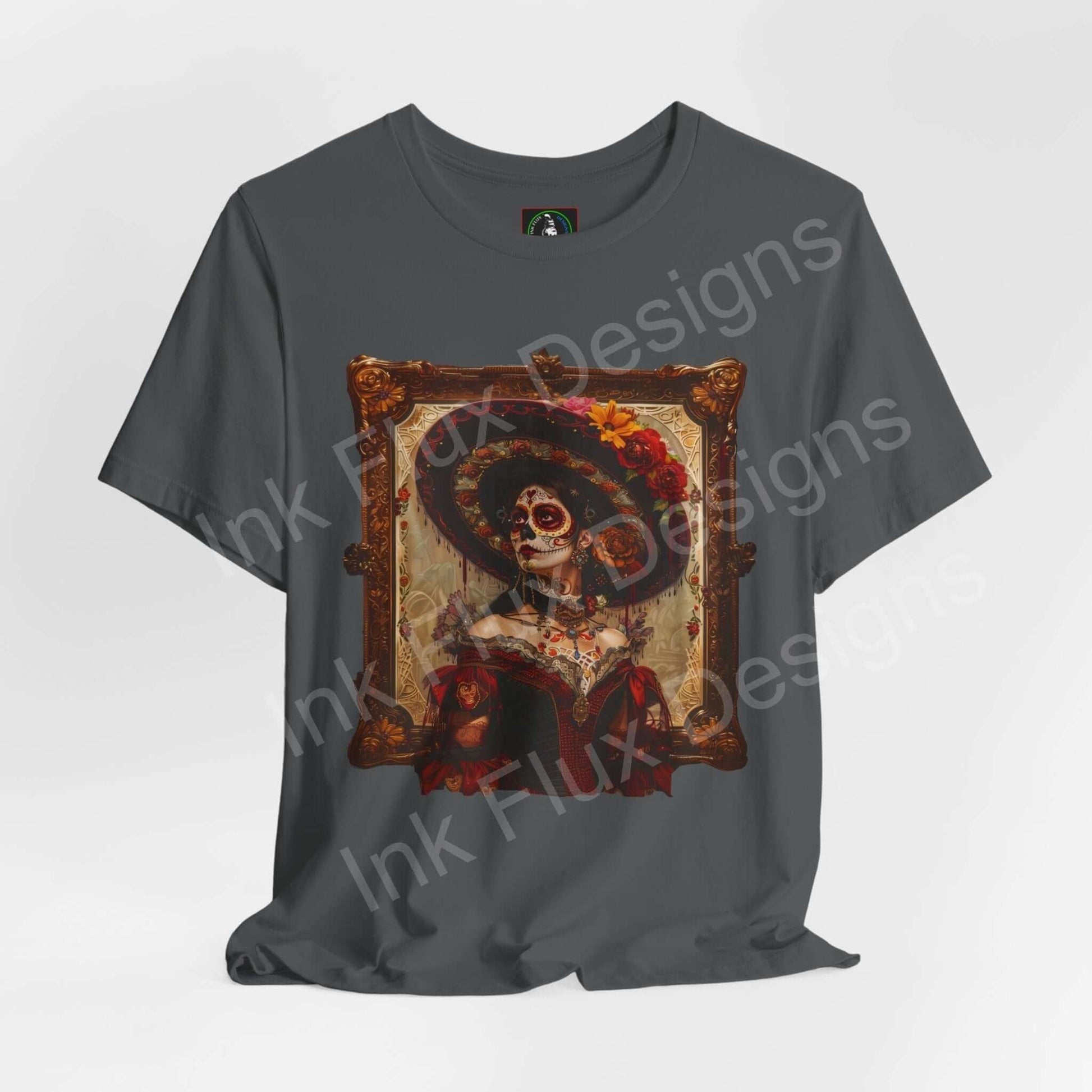 Day of the Dead themed graphic tee featuring a Día de Muertos inspired design with a skeleton in traditional attire, on a gray T-shirt.
