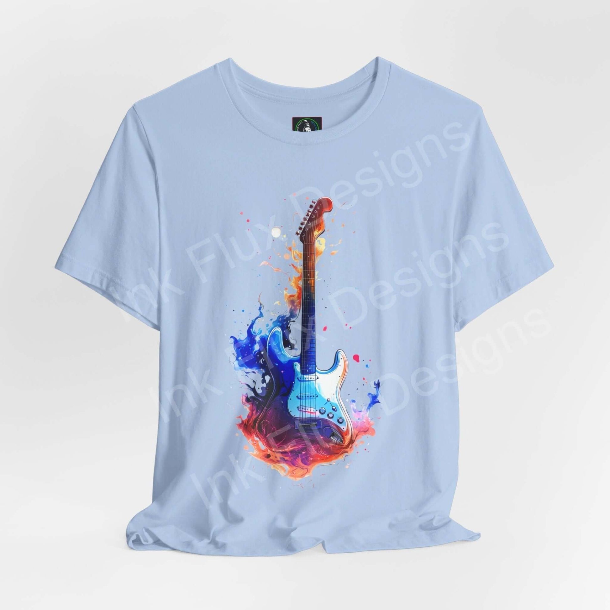 Light blue unisex t-shirt featuring bold graphic of a guitar engulfed in colorful flames, crafted from soft Airlume cotton by Bella+Canvas.