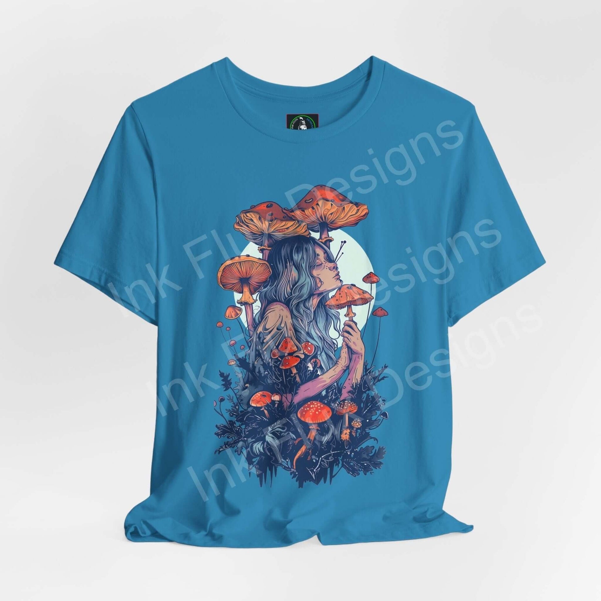 Unisex turquoise tee featuring a bold, psychedelic graphic of a woman with mushroom and floral imagery, from the 'Mushroom Lady VI' series by Bella+Canvas.