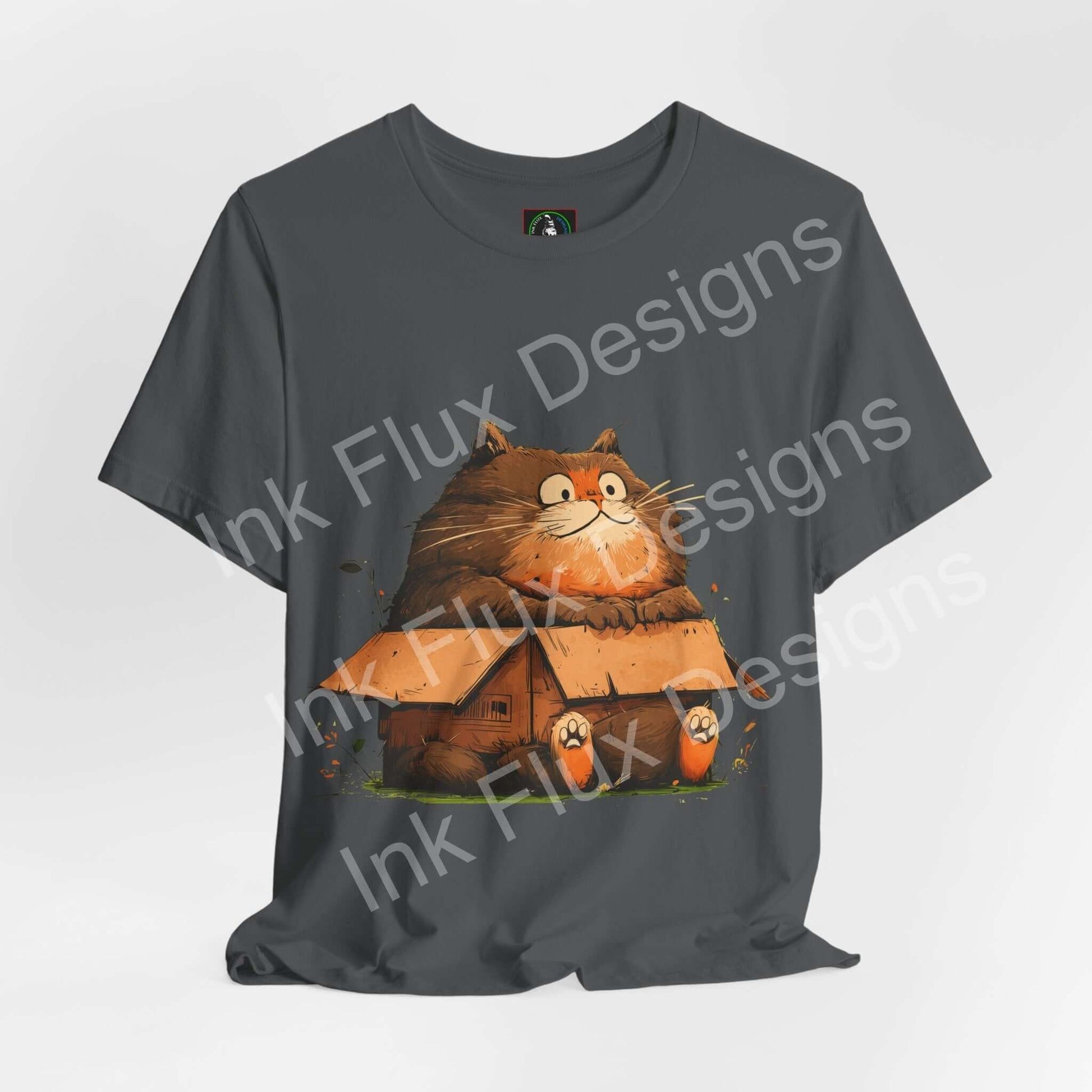 Funny Cat T-Shirt featuring a chunky cat sitting in a tiny house, capturing playful cat behavior.