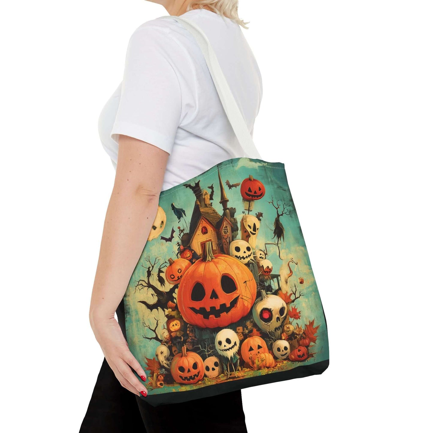 Woman carrying a tote bag with a vibrant all-over print of jack o'lanterns and haunted house theme, showcasing the bag's polyester material and sturdy straps.