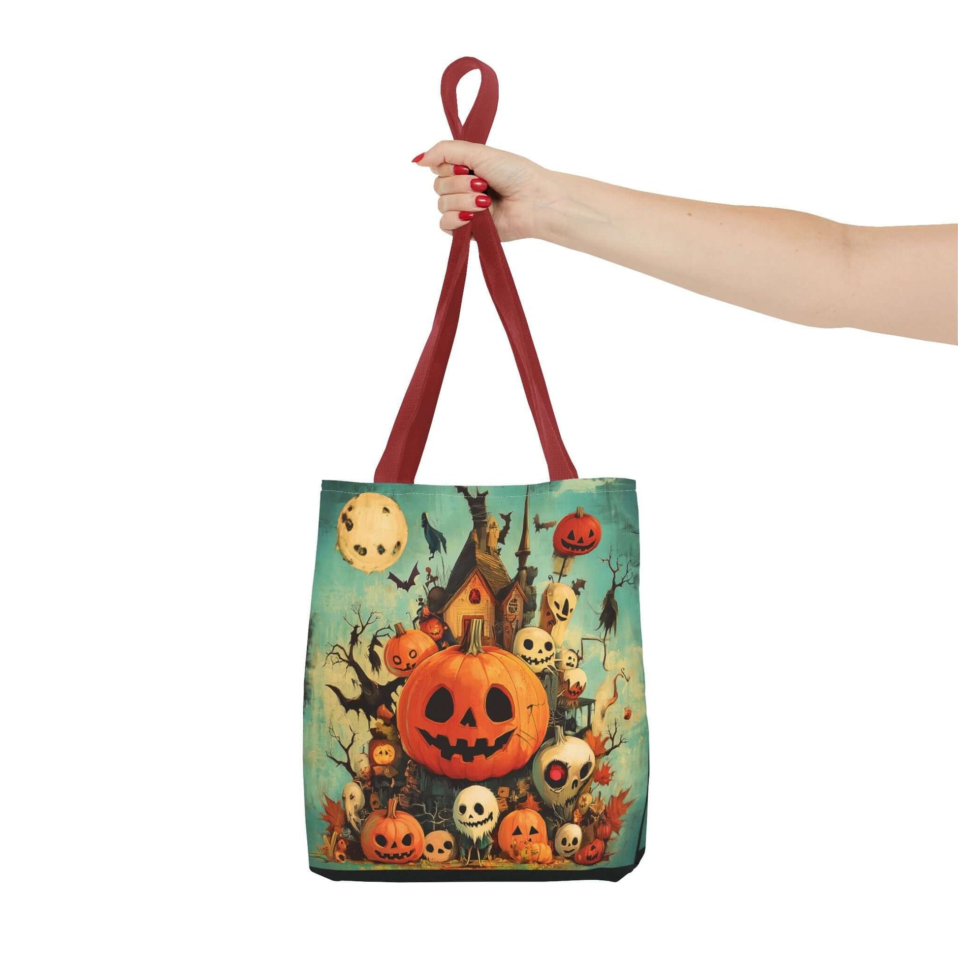 Stylish tote bag featuring a vibrant all-over print of jack-o-lanterns on a porch, held by a hand with red nails, perfect for Halloween.