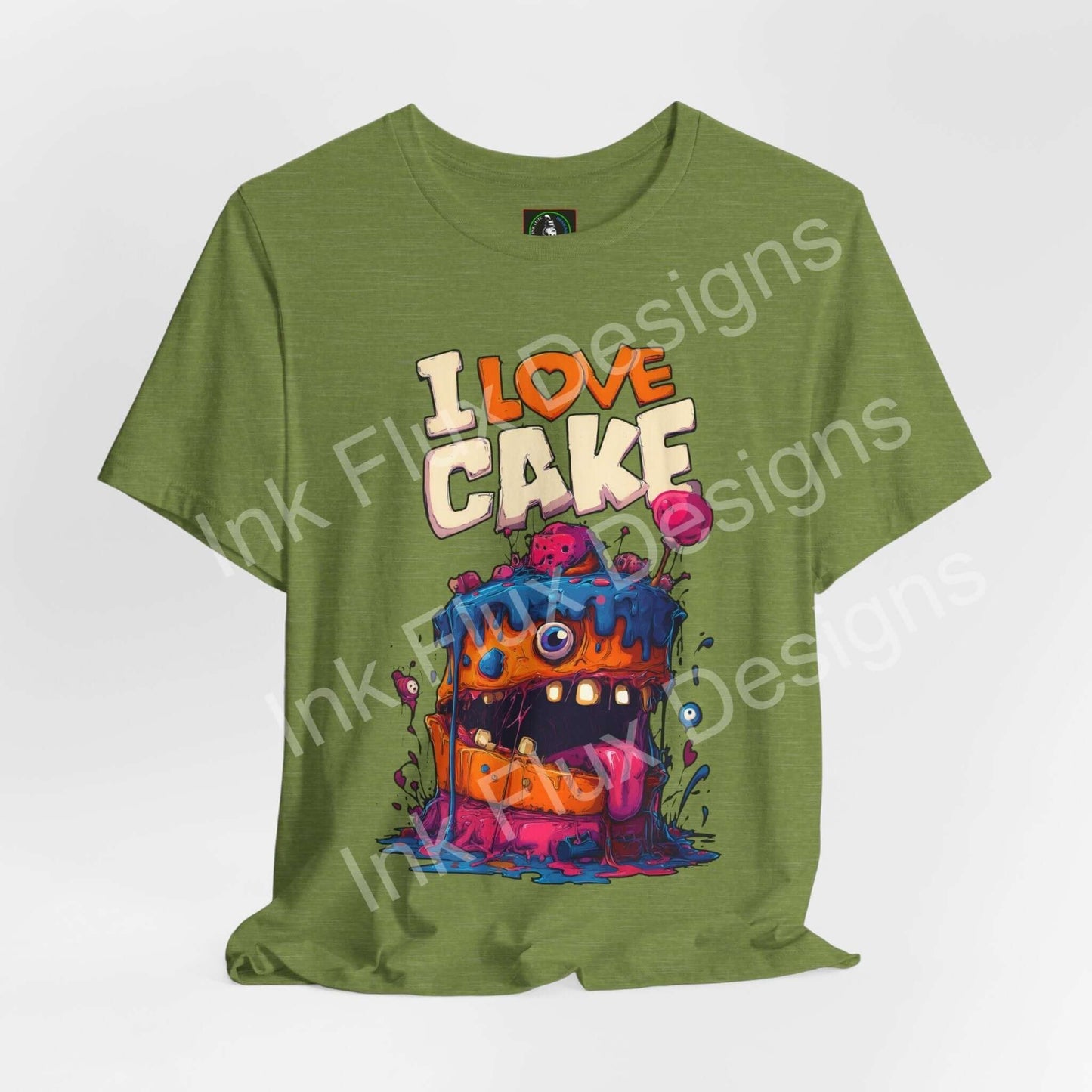 I Love Cake II Funny Graphic T-Shirt featuring a cartoon monster cake with colorful frosting and a happy expression.