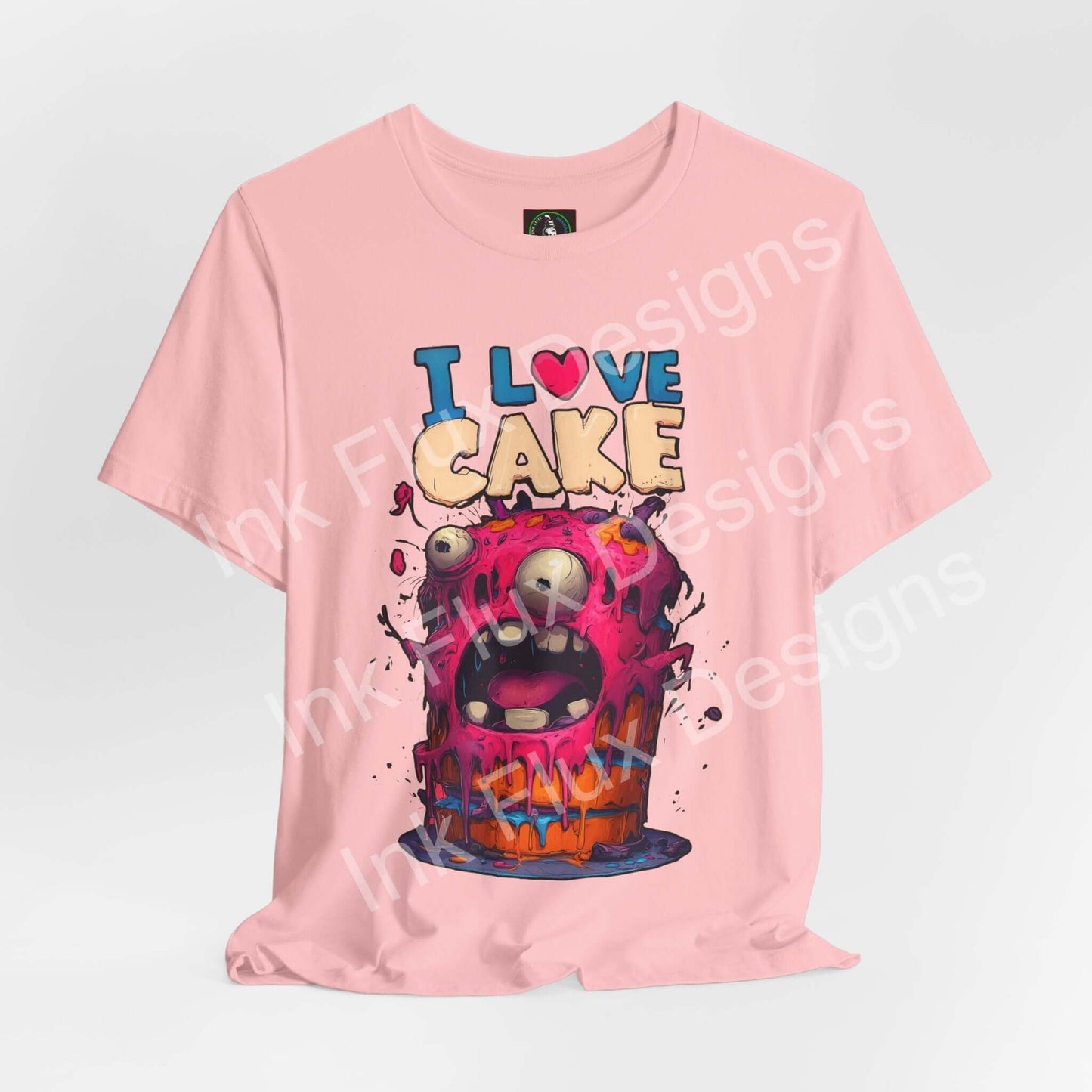I Love Cake Funny Graphic T-Shirt featuring a monster cake cartoon design with vibrant colors and humorous expression.
