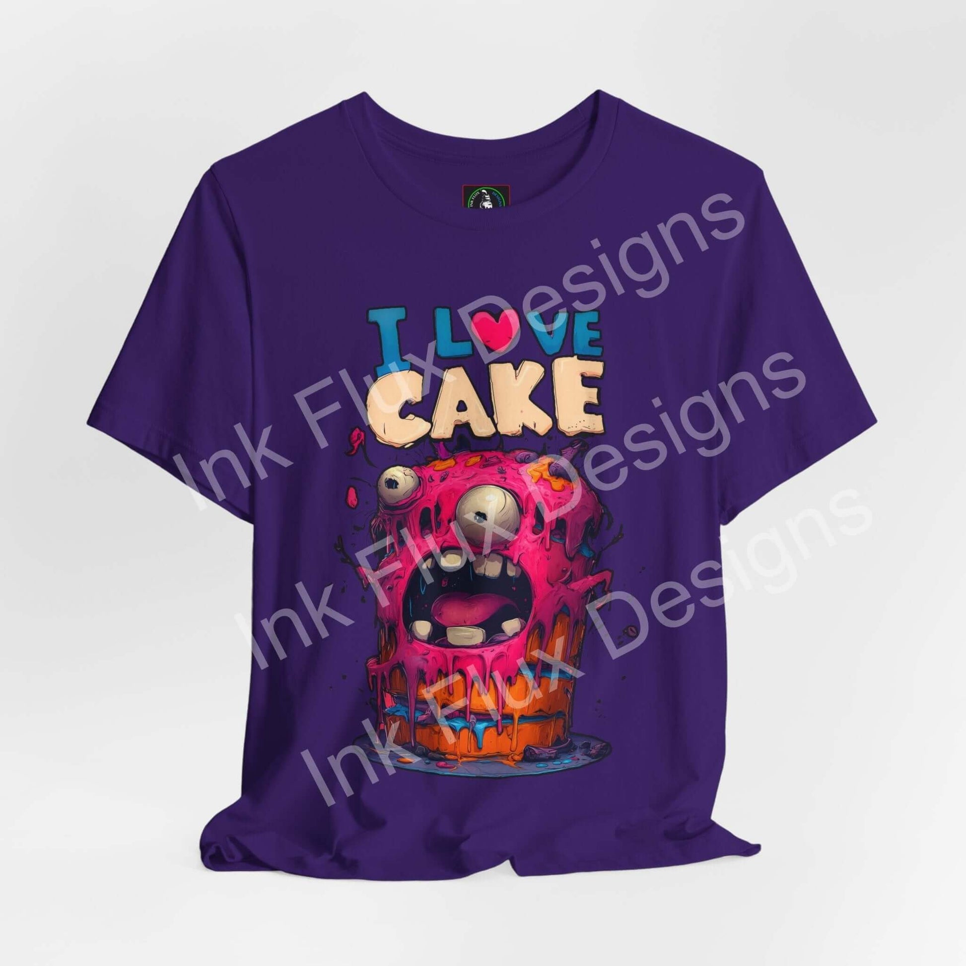 I Love Cake Funny Graphic T-Shirt featuring a colorful monster cake with expressive eyes and playful design.