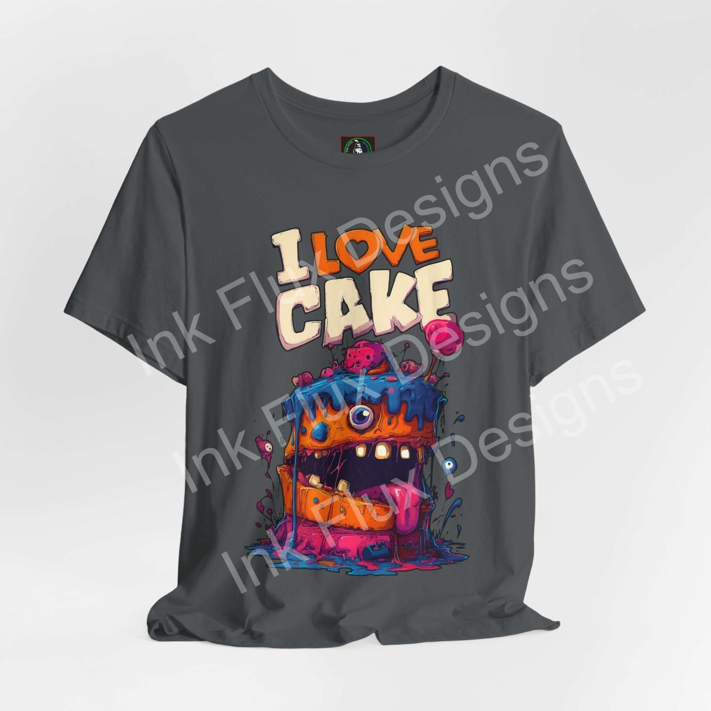 Funny Graphic T-Shirt featuring a colorful monster cake with oversized eyes and a playful grin.