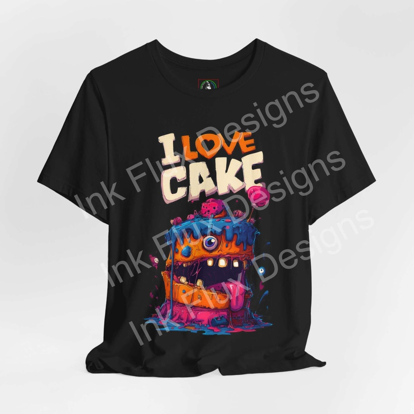 I Love Cake II Funny Graphic T-Shirt featuring a colorful monster cake design with bold cartoon art and exaggerated features.