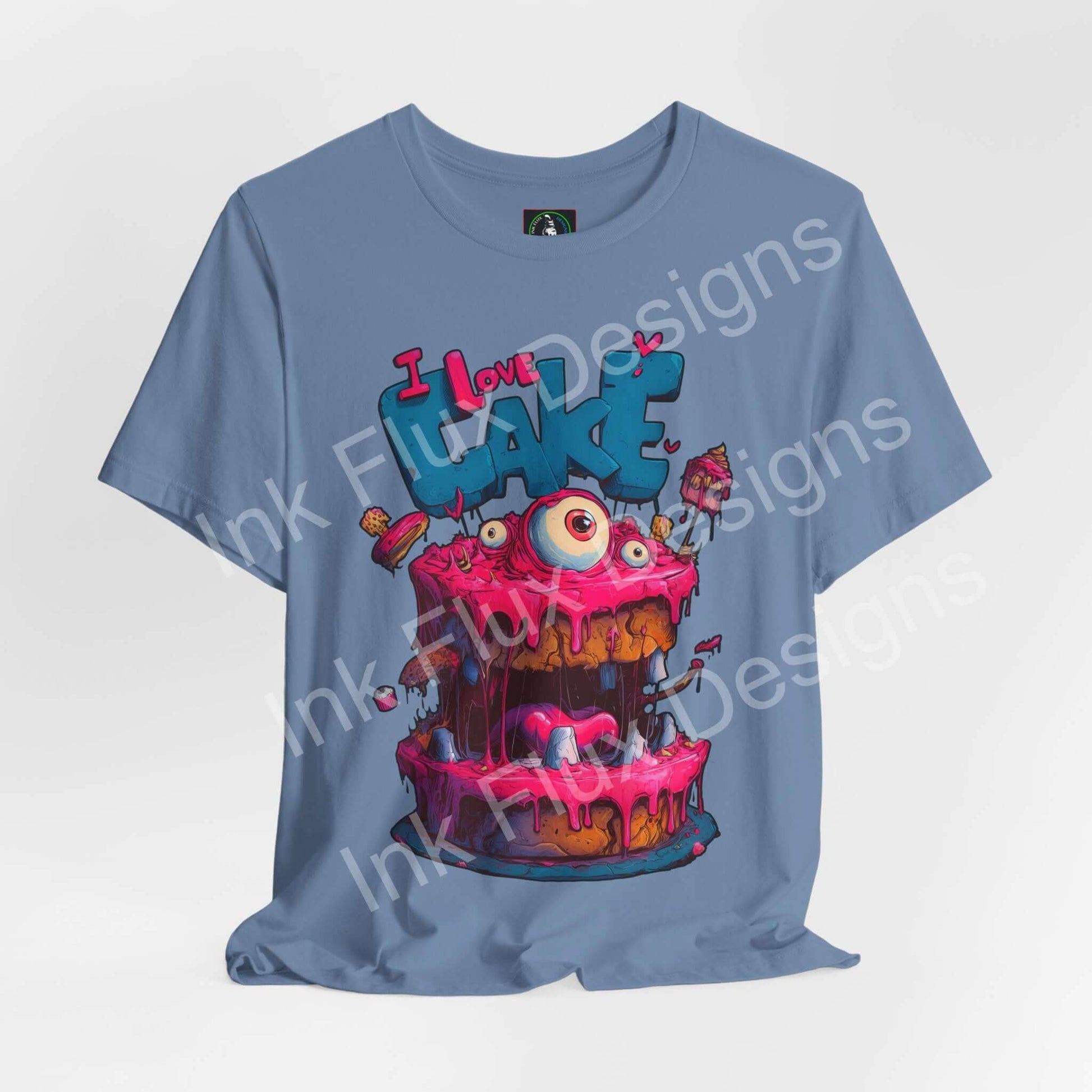I Love Cake III Funny Graphic T-Shirt featuring a colorful monster cake design with oversized eyes and dripping icing.
