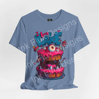 I Love Cake III Funny Graphic T-Shirt featuring a colorful monster cake design with oversized eyes and dripping icing.