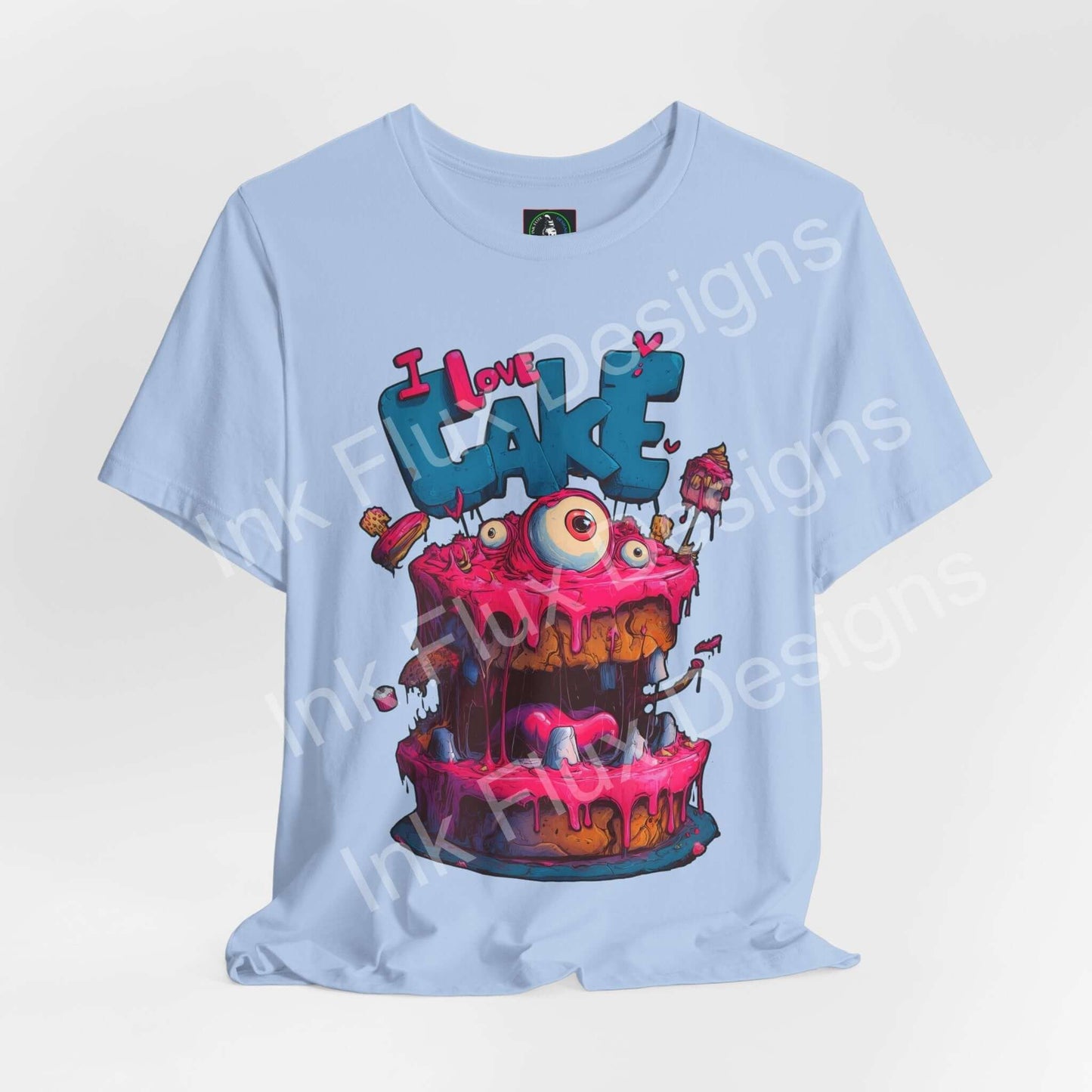I Love Cake III Funny Graphic T-Shirt featuring a colorful monster cake design with oversized eyes and dripping icing.