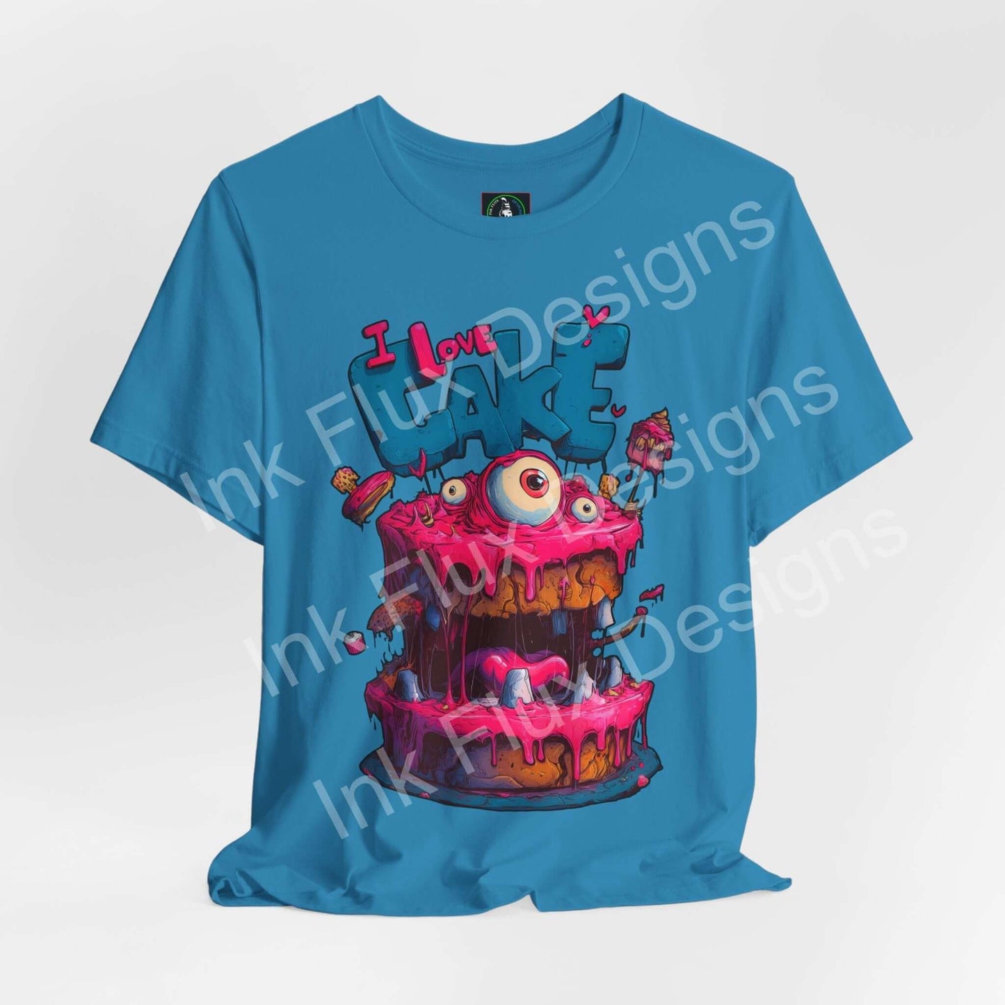 Funny Graphic T-Shirt featuring a colorful Monster Cake with oversized eyes and dripping pink icing.