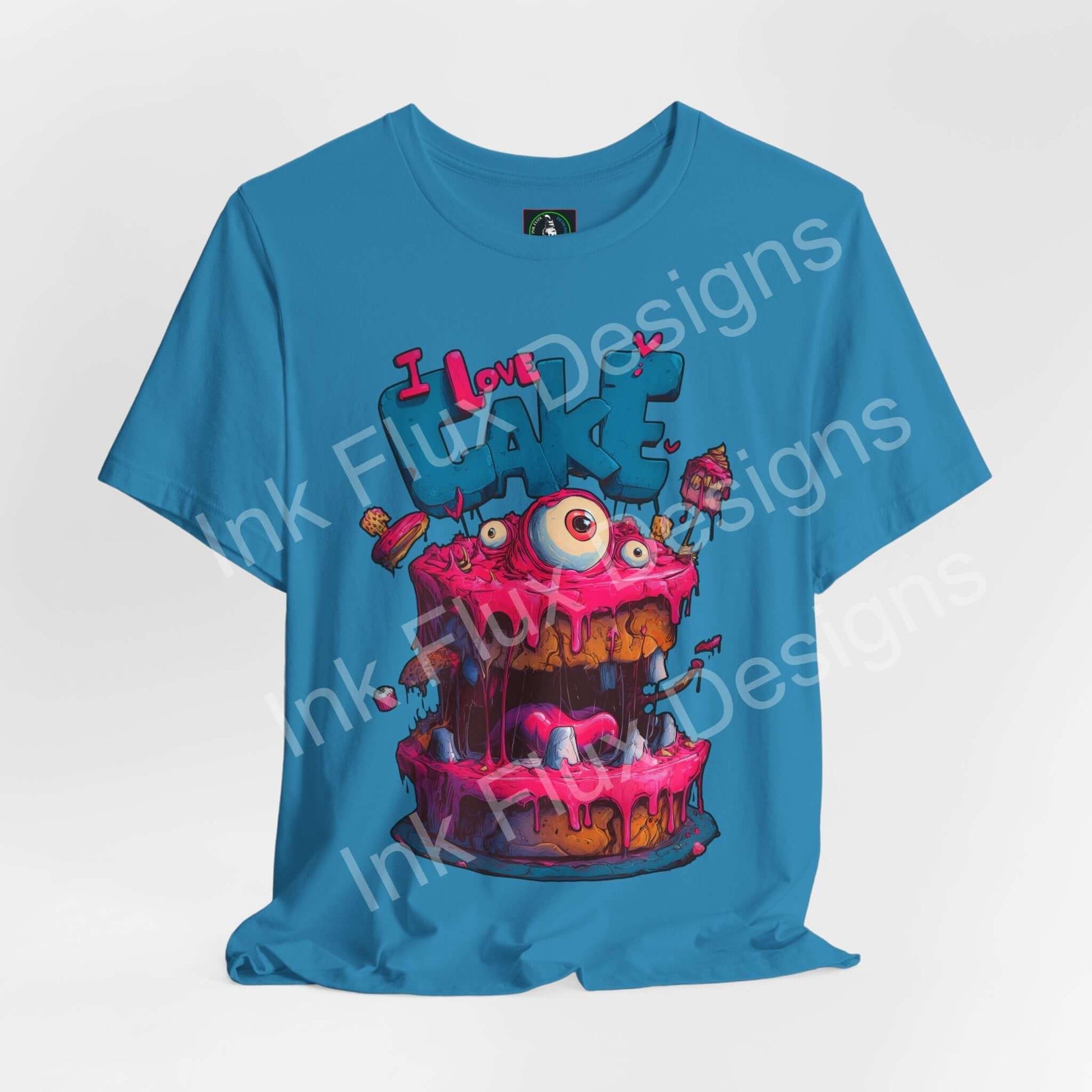 Funny Graphic T-Shirt featuring a colorful Monster Cake with oversized eyes and dripping pink icing.