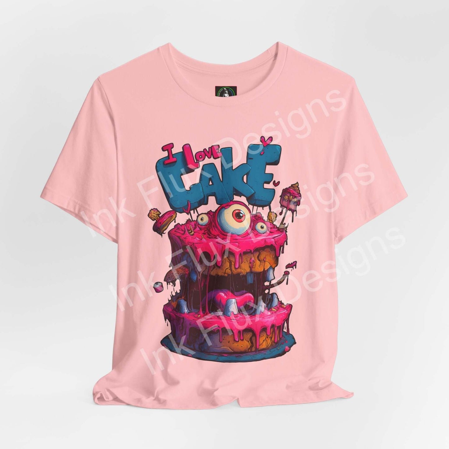 Funny Graphic T-Shirt featuring a colorful monster cake design with oversized eyes and pink icing.