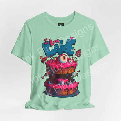 I Love Cake III Funny Graphic T-Shirt featuring a monster cake cartoon design with colorful frosting and oversized eyes.