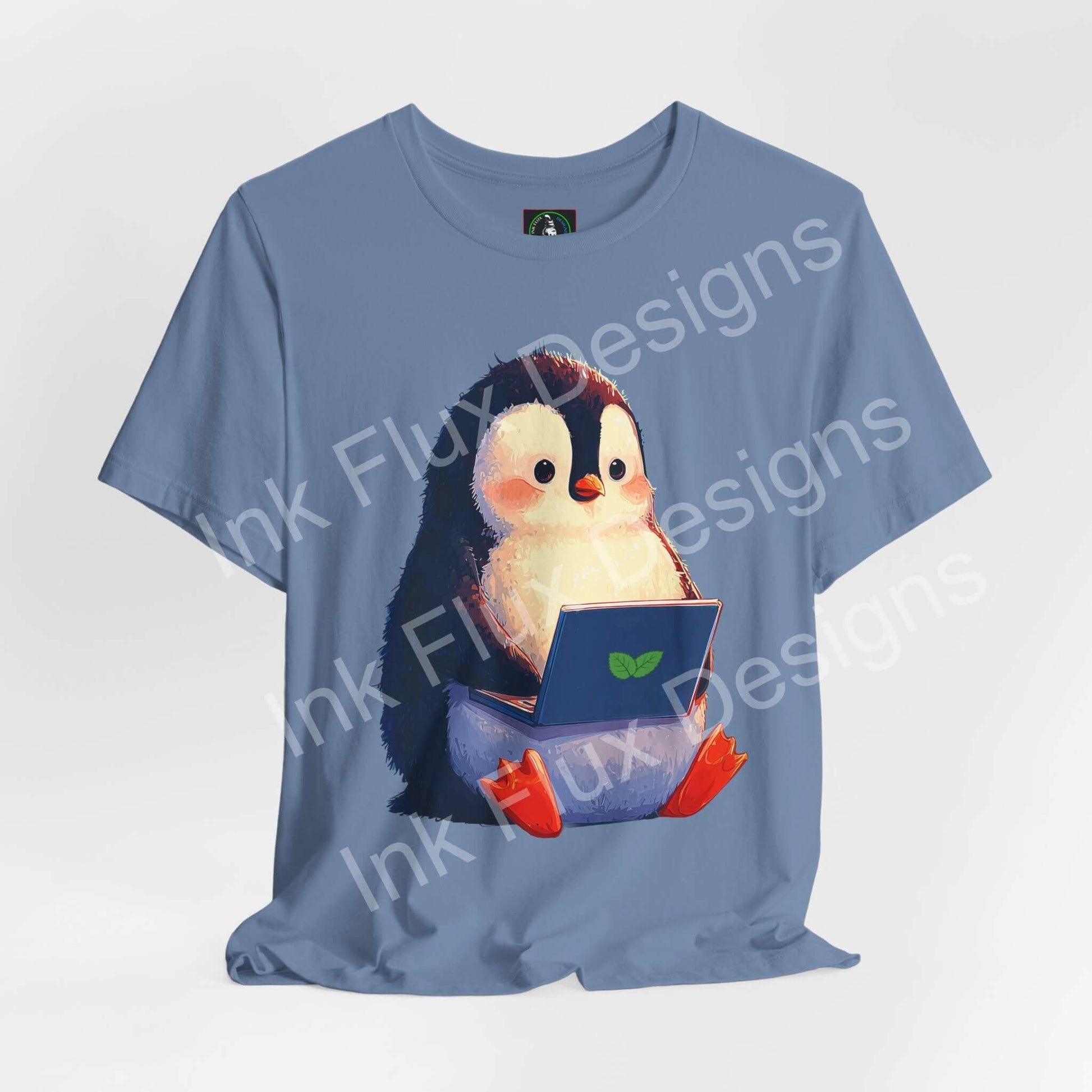 Minty Penguin Fun Graphic T-Shirt featuring a cute penguin with a laptop design on a blue tee.