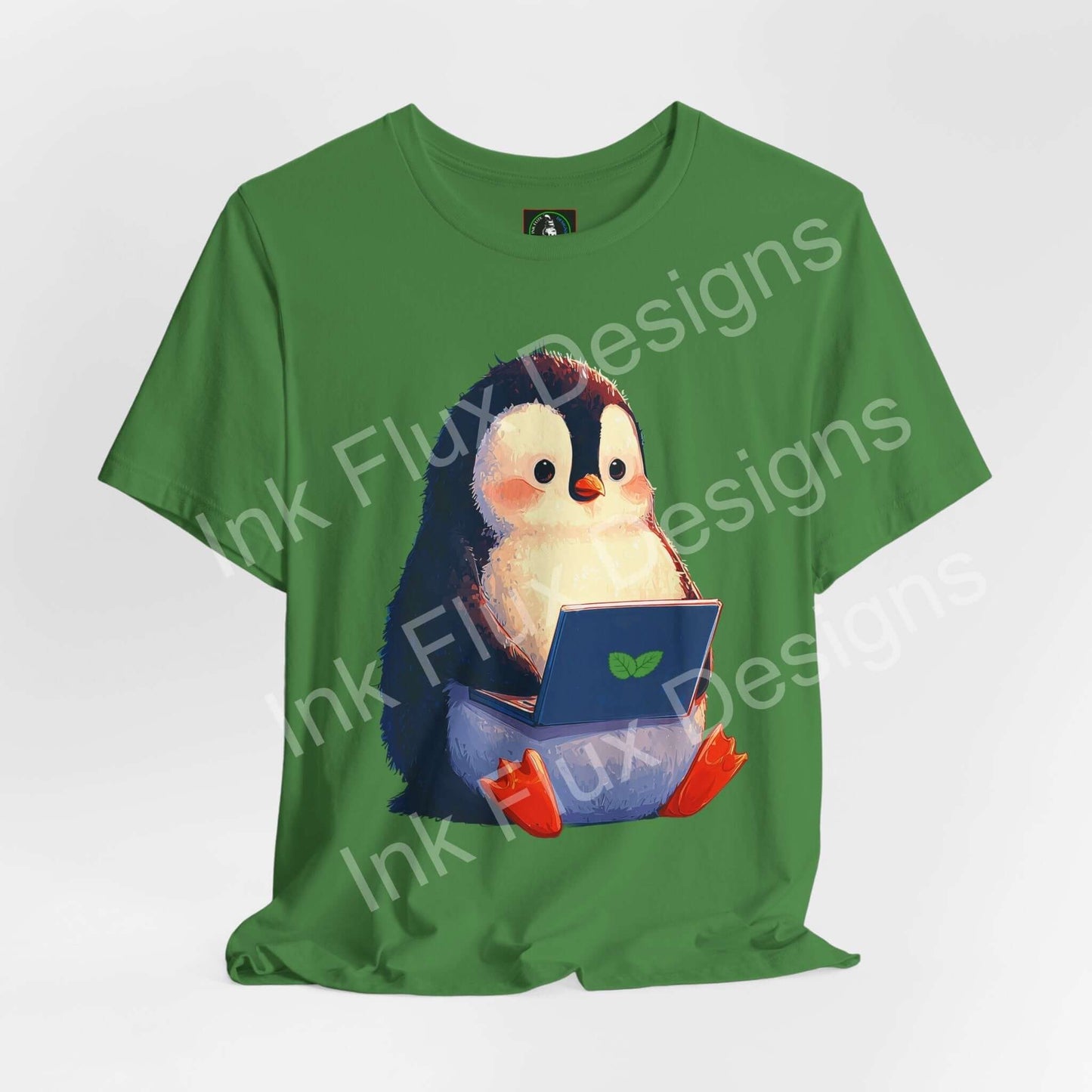 Minty Penguin Fun Graphic T-Shirt featuring an adorable penguin with a laptop on a green tee.