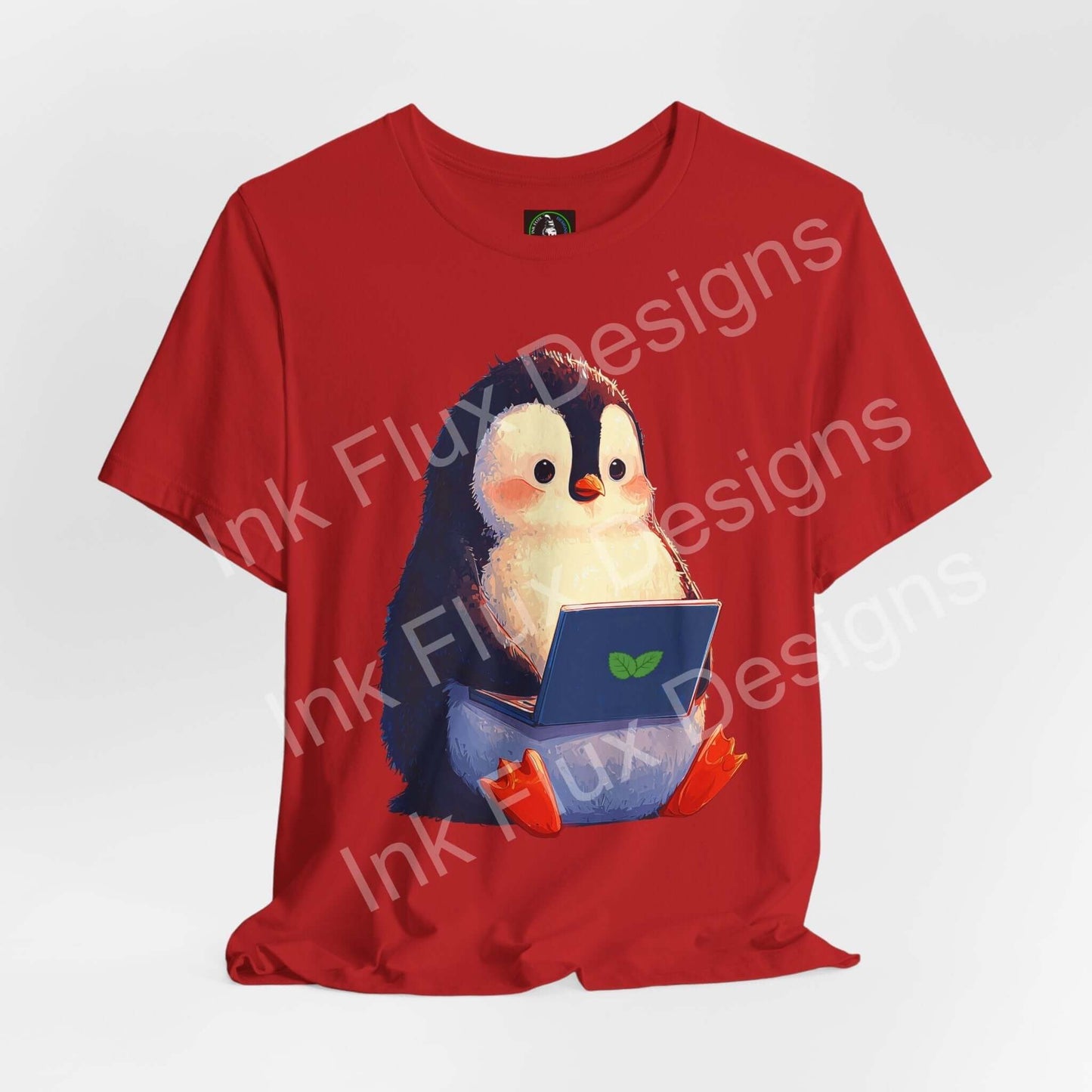 Minty Penguin Fun Graphic T-Shirt featuring an adorable penguin with a laptop on a red background.