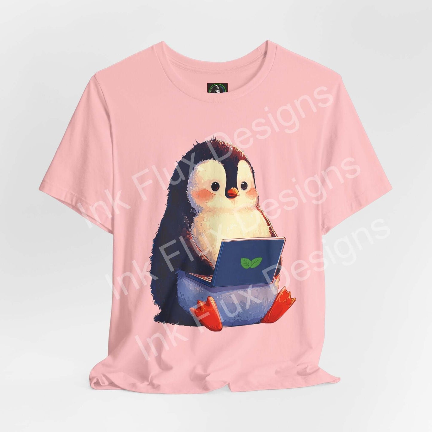 Minty Penguin Fun Graphic T-Shirt featuring a cute penguin with a laptop on a pink tee.