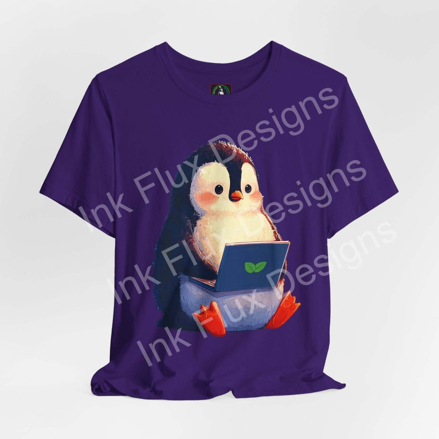 Minty Penguin Fun Graphic T-Shirt featuring an adorable penguin with a laptop on a purple tee.