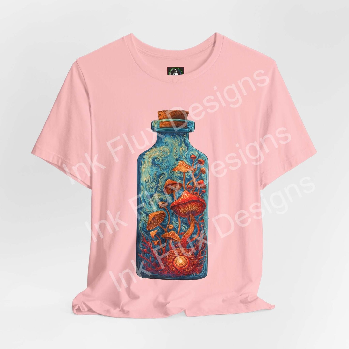 Psychedelic T-Shirt Ember Mycelium features vibrant mushroom bottle graphic on soft pink fabric.