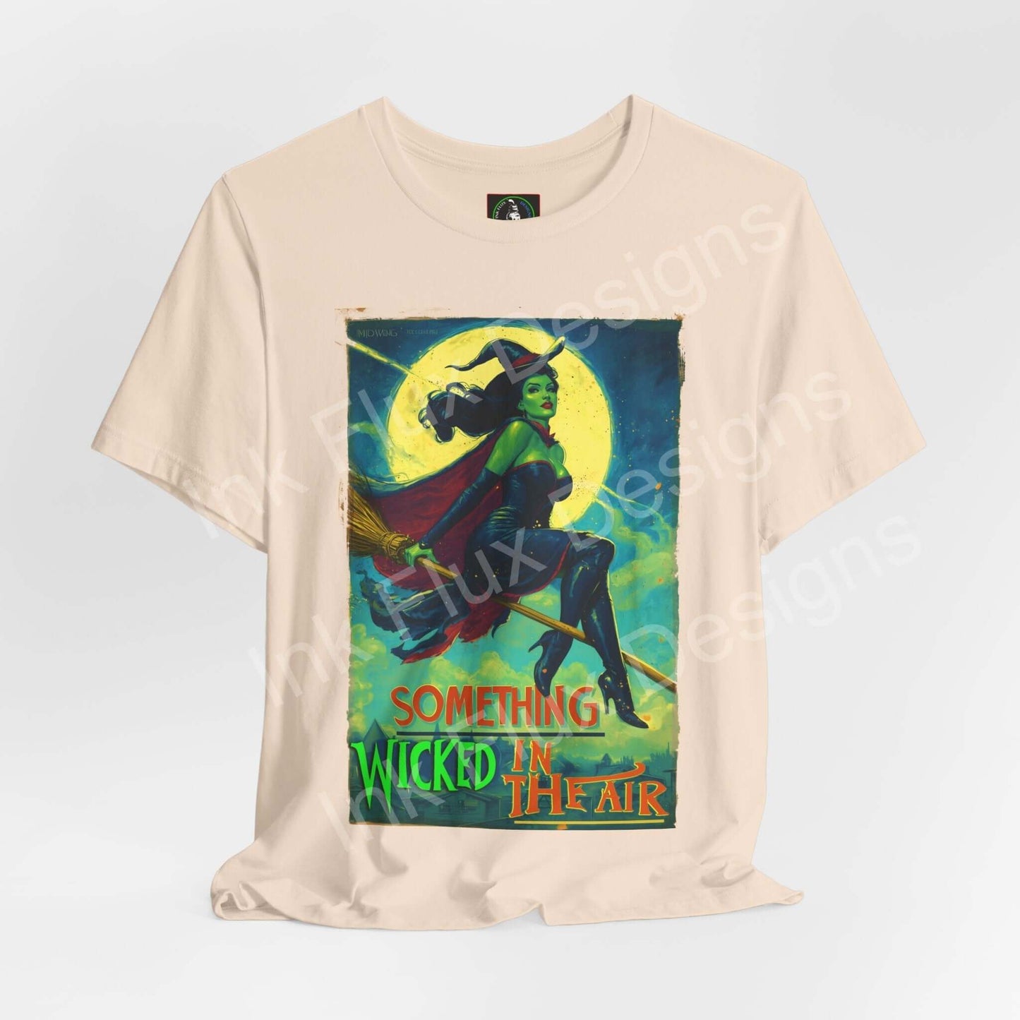 Halloween witch t-shirt featuring a witch flying on a broom with the phrase 'Something Wicked in the Air'.