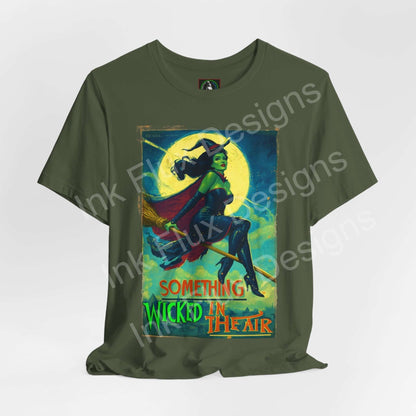 Halloween witch t-shirt featuring the phrase "Something Wicked in the Air" on a green background.