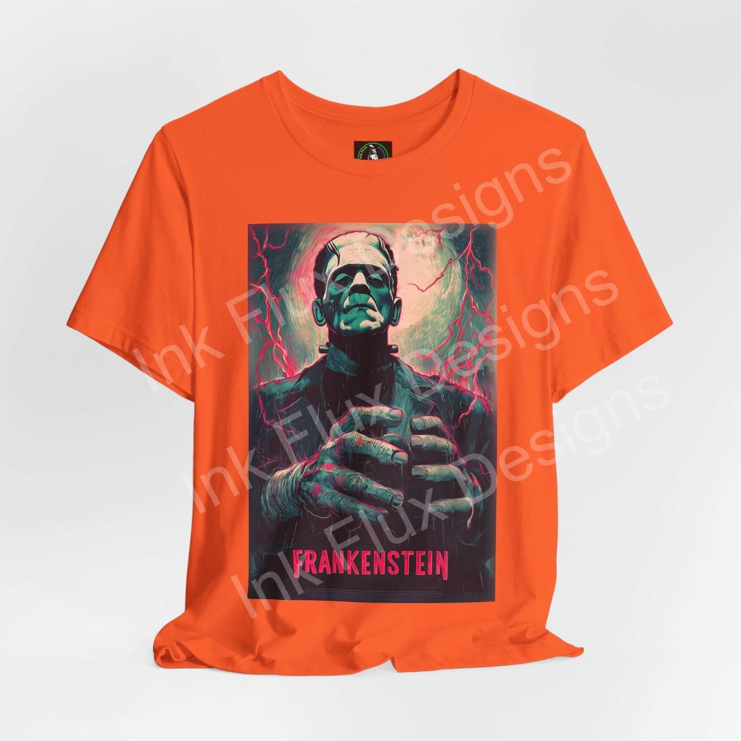 Frankenstein t-shirt featuring a vibrant graphic design of the iconic monster on an orange unisex tee by Ink Flux Designs.