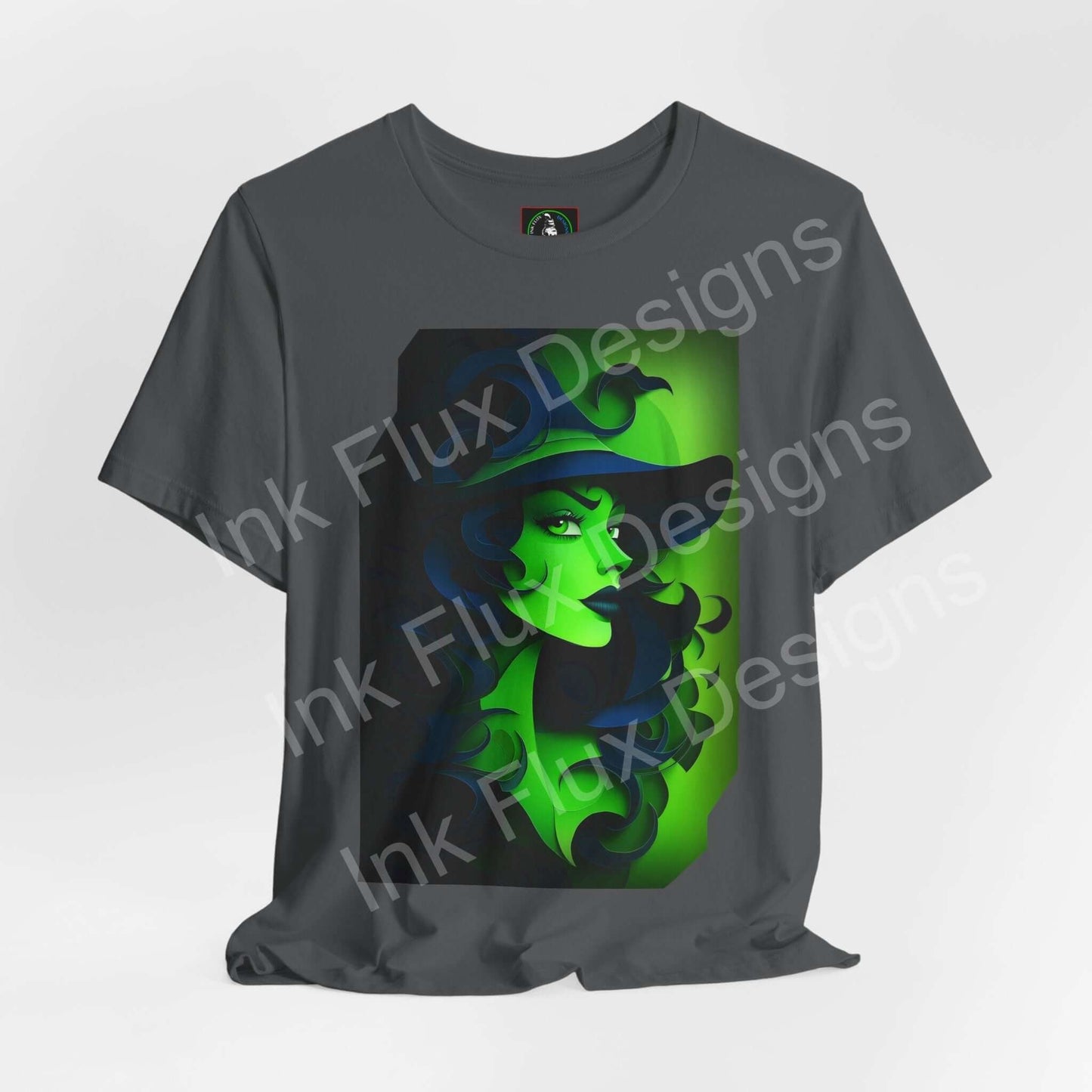Green Witch T-Shirt featuring a paper cut-out design in vibrant green on a grey background.